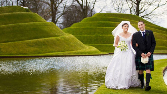 a Scottish wedding couple wearing traditional dress including kilt